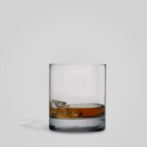 Whiskey Glass with whiskey Italian Made with gray Background